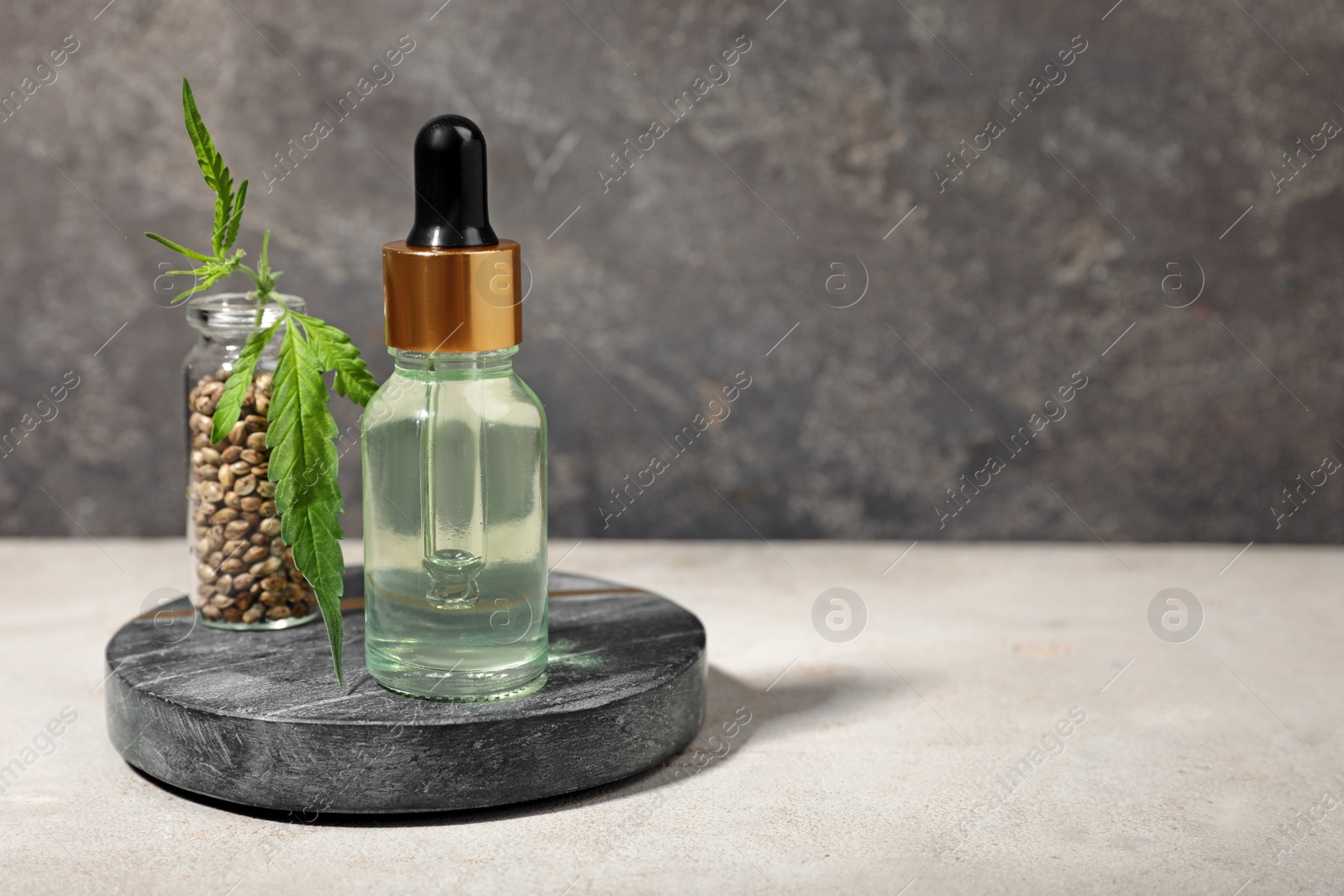 Photo of Hemp cosmetic product, seeds and leaf on white wooden table. Space for text