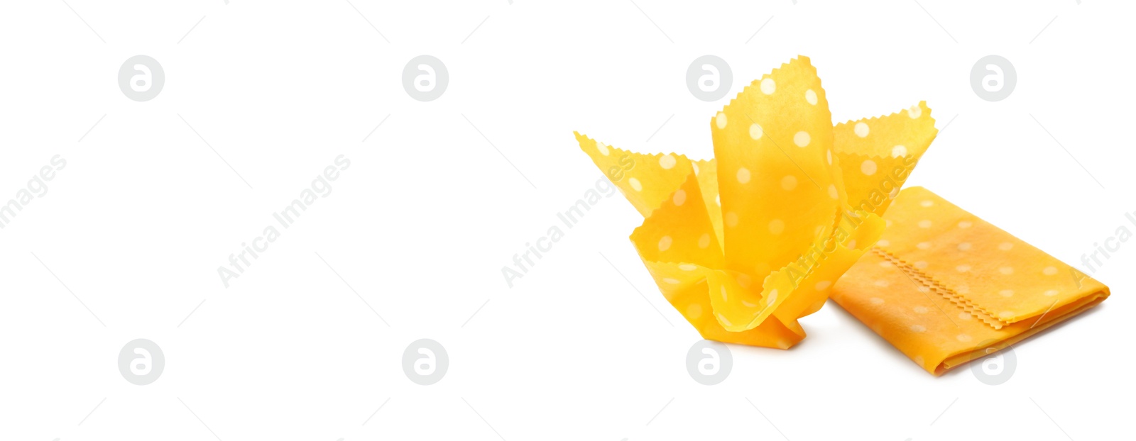 Image of Yellow beeswax food wraps on white background, banner design