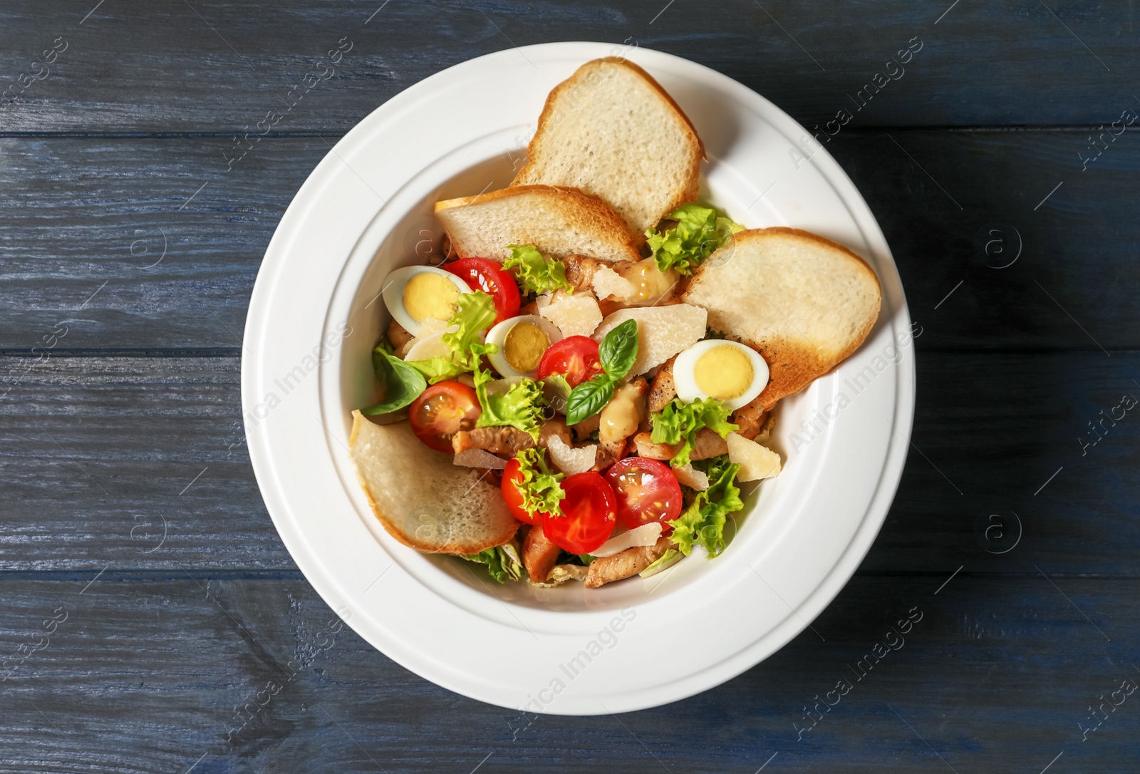 Photo of Plate with delicious fresh salad on table, top view