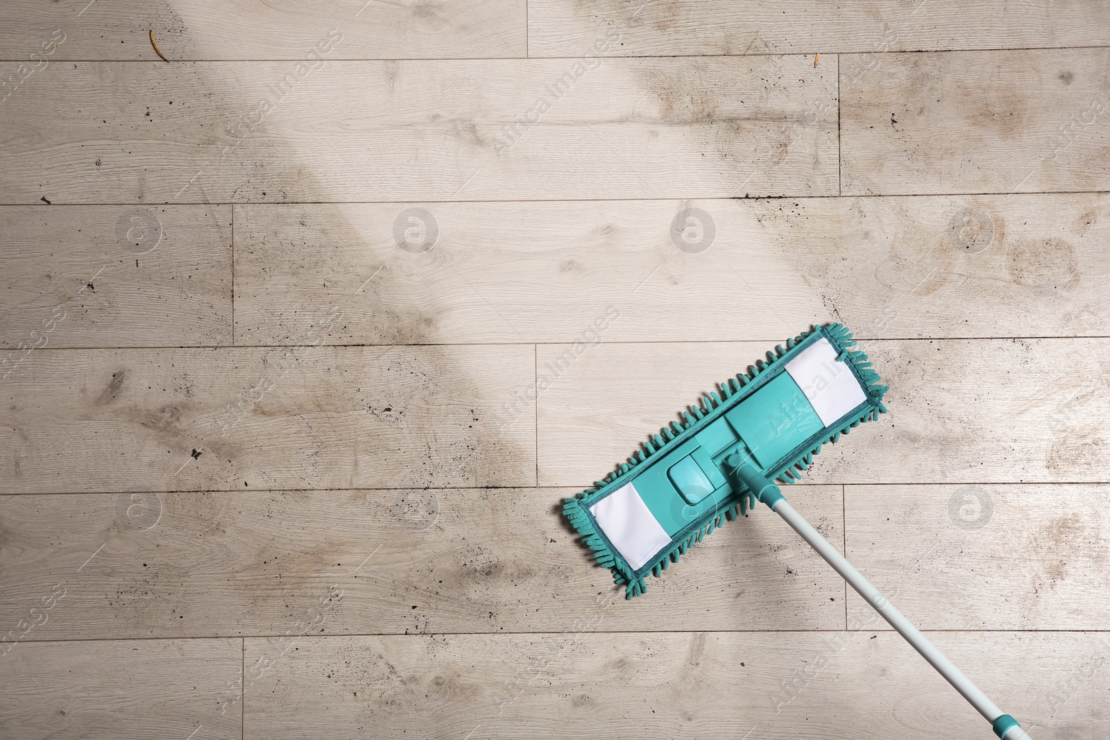 Photo of Washing of dirty floor with mop, top view. Space for text