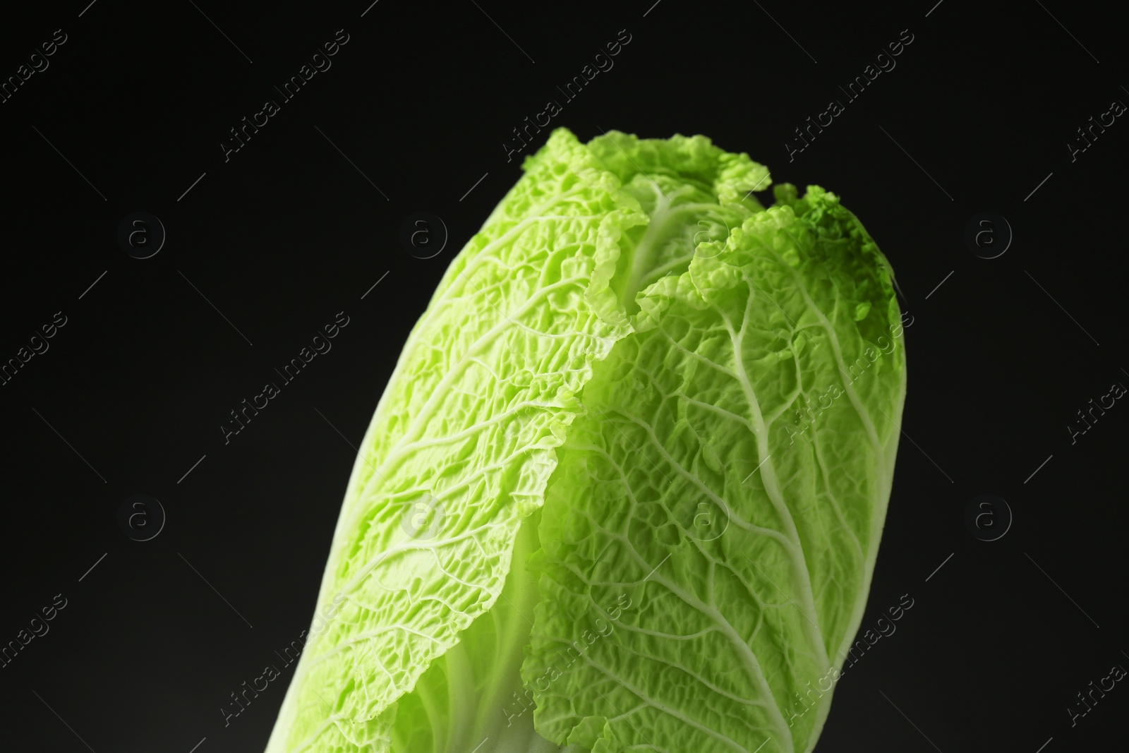 Photo of Fresh ripe Chinese cabbage on black background, closeup