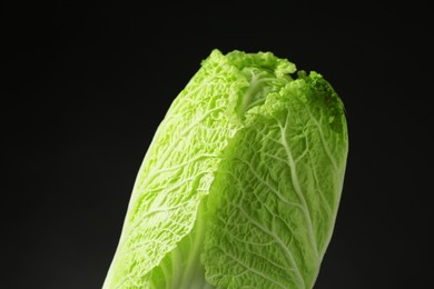 Photo of Fresh ripe Chinese cabbage on black background, closeup