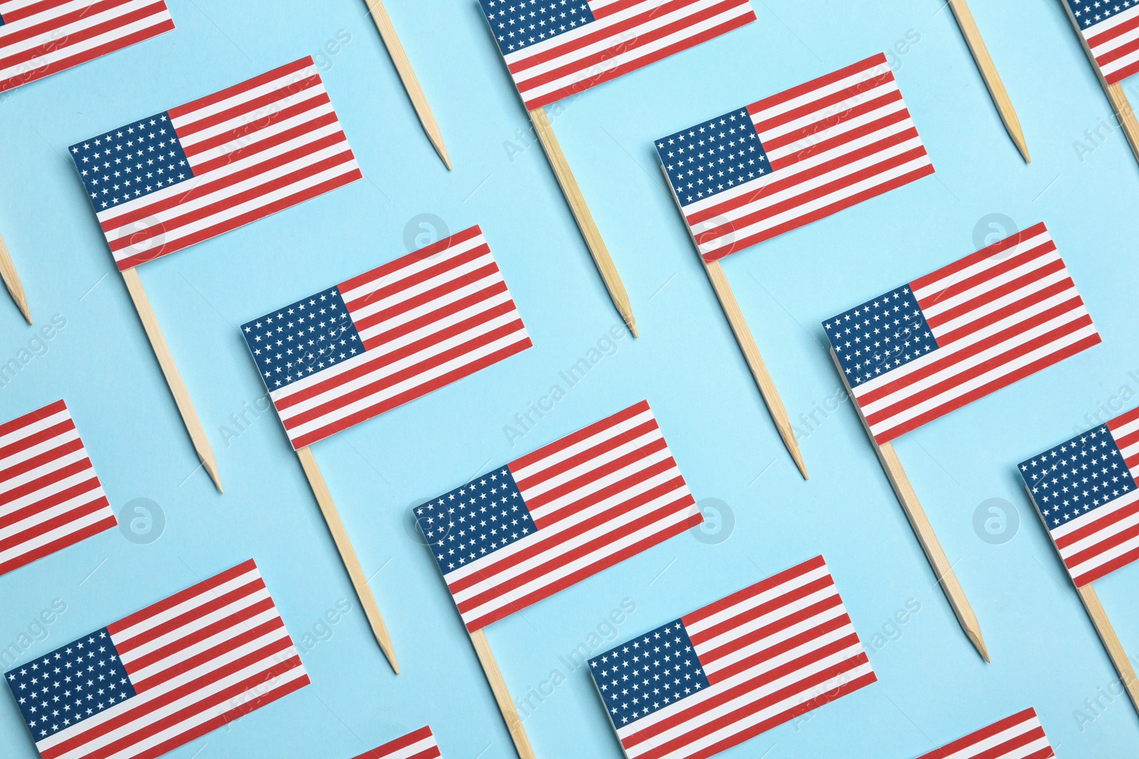 Photo of Flat lay composition of USA flags on color background. Happy Independence Day