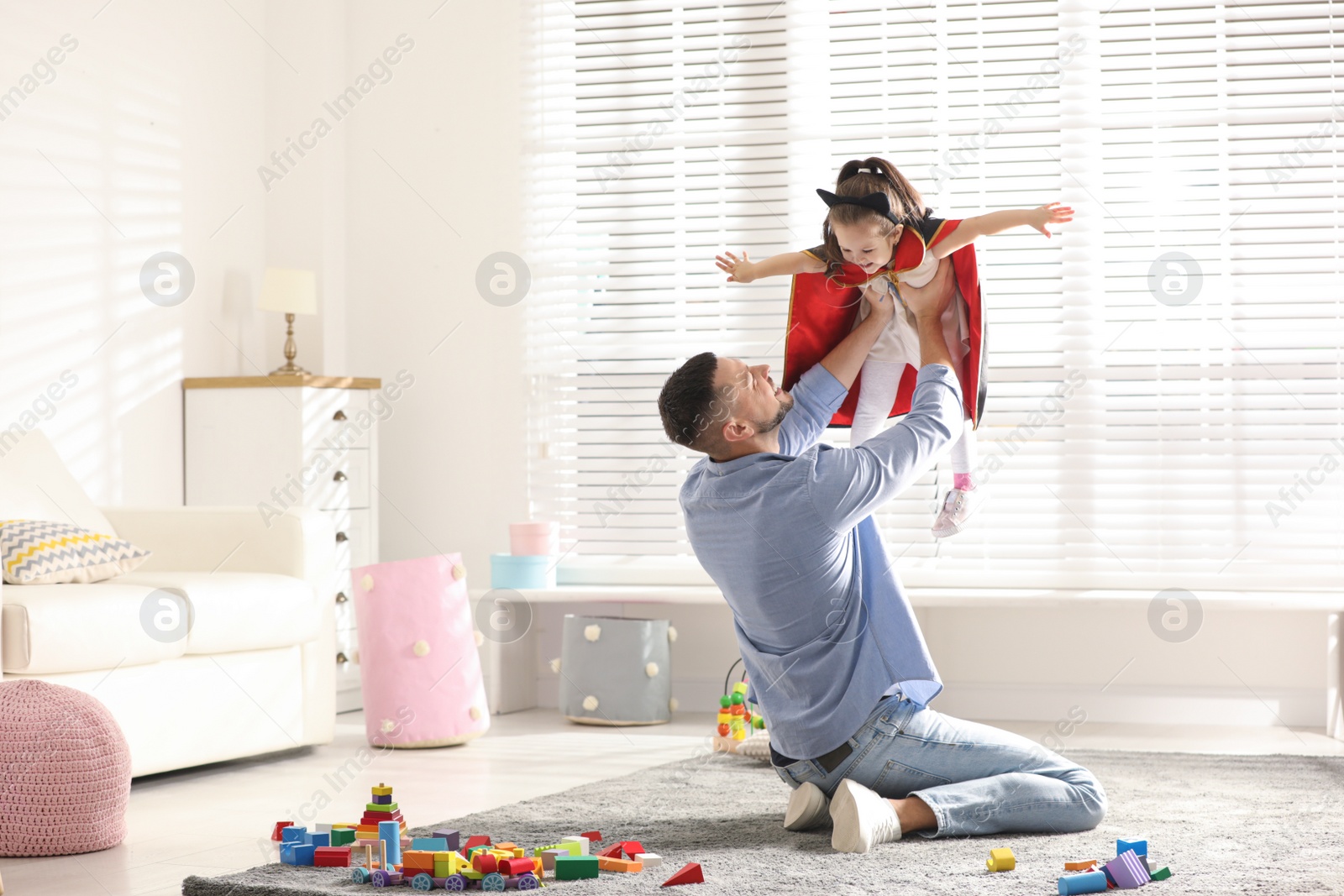 Photo of Father playing with his child at home