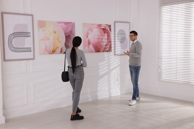 People viewing exposition in modern art gallery