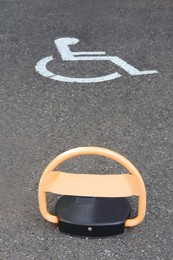 Photo of Barrier on parking place for people with disability outdoors