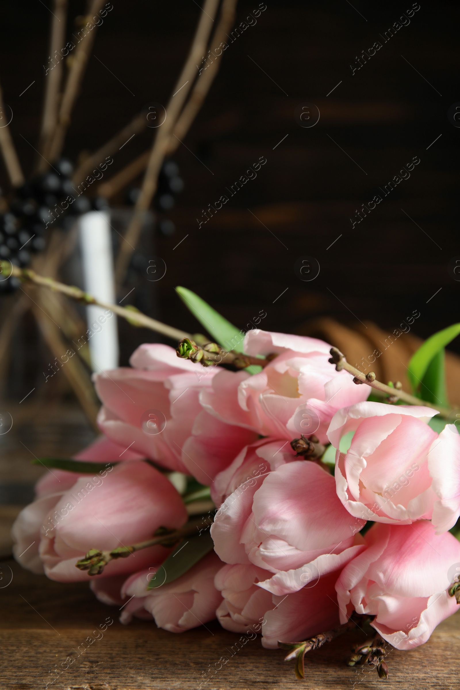 Photo of Beautiful bouquet of spring pink tulips on wooden table