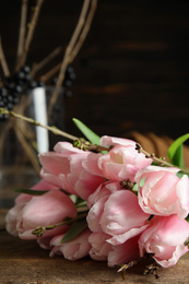 Photo of Beautiful bouquet of spring pink tulips on wooden table