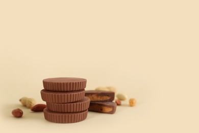 Sweet peanut butter cups on beige background. Space for text