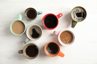 Photo of Flat lay composition with cups of coffee on light background. Food photography