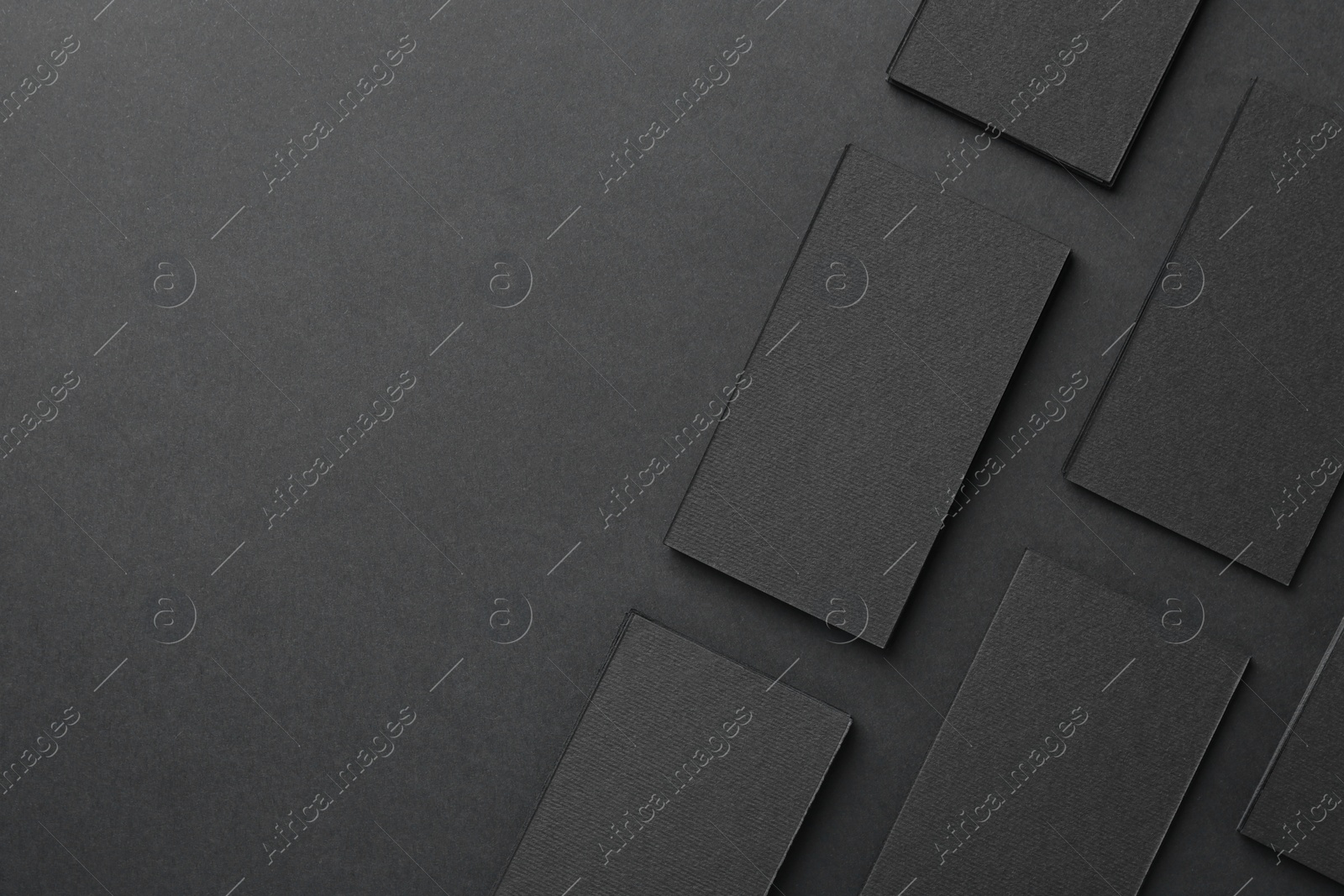 Photo of Blank business cards on black background, flat lay. Mockup for design