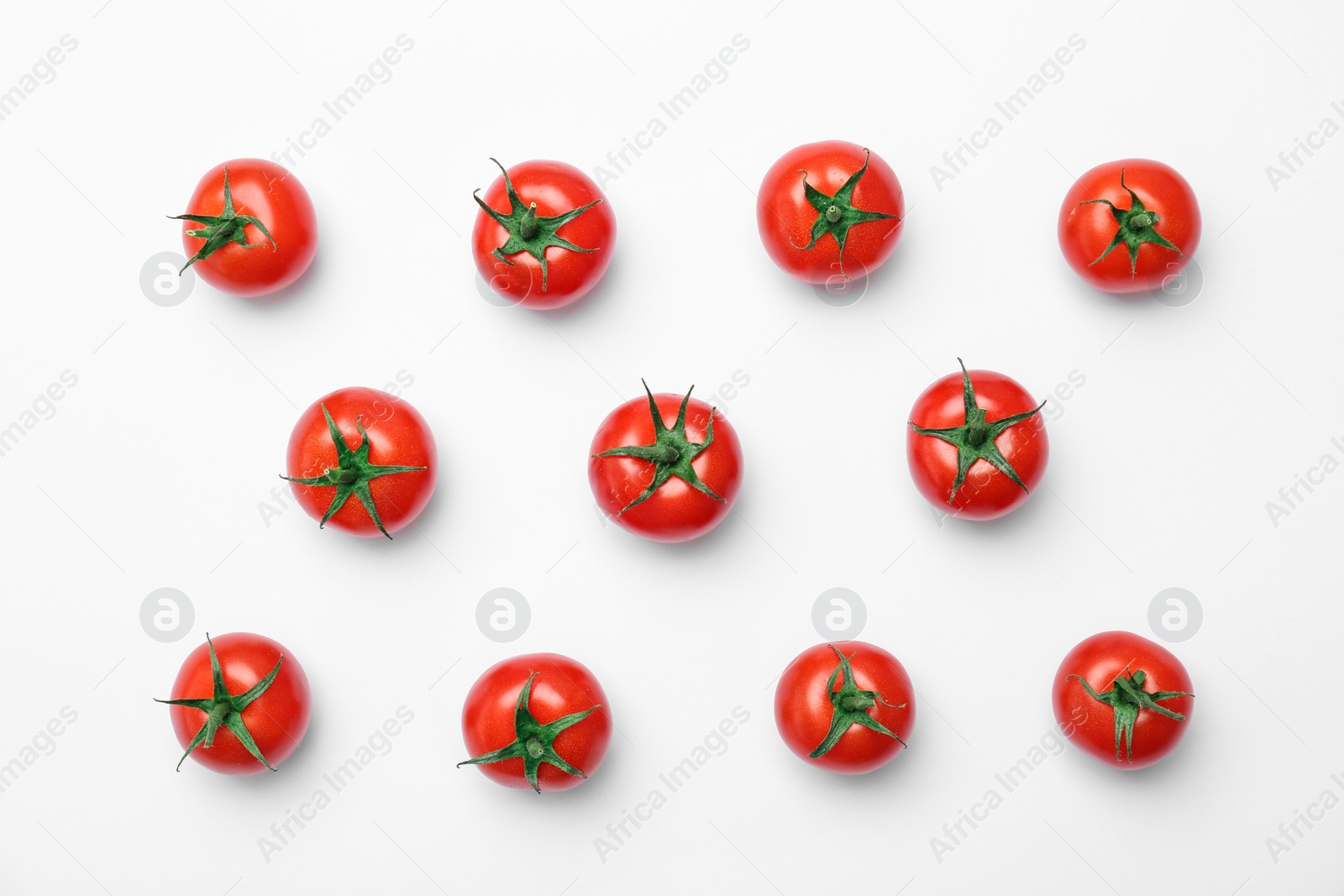 Photo of Flat lay composition with ripe tomatoes on light background