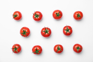 Flat lay composition with ripe tomatoes on light background