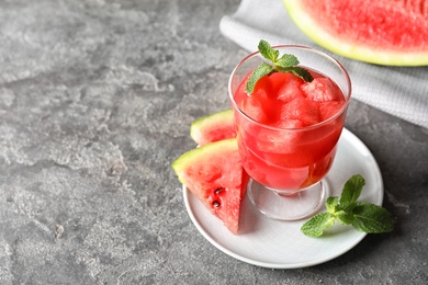 Photo of Tasty summer watermelon drink in glass and space for text on table