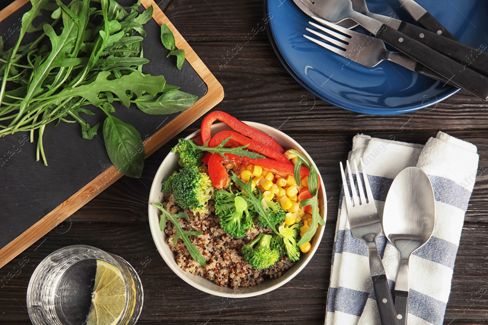 Photo of Bowl with quinoa and different vegetables on table, top view