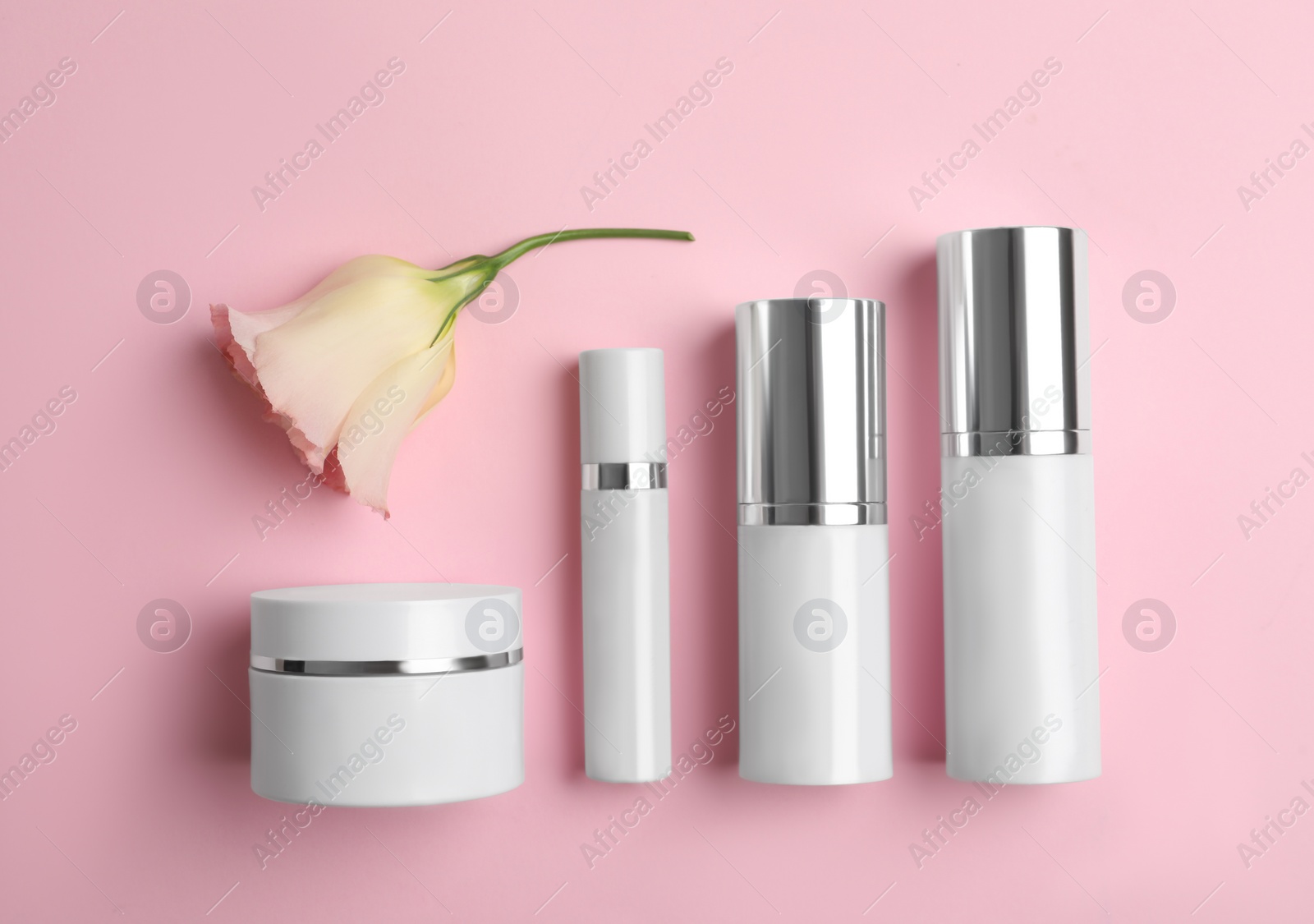Photo of Set of luxury cosmetic products on pink background, flat lay