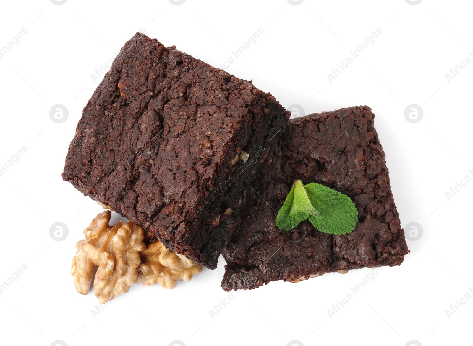 Photo of Delicious brownies with walnuts and mint on white background, top view