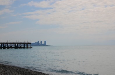 Photo of Picturesque view of pier near beautiful calm sea