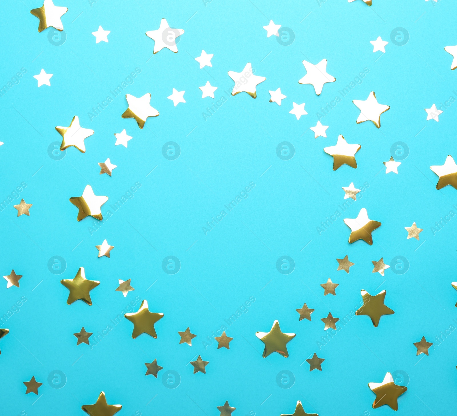 Photo of Frame made of confetti stars with space for text on blue background, top view. Christmas celebration