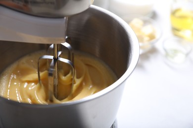 Making dough in bowl of stand mixer on white table, closeup