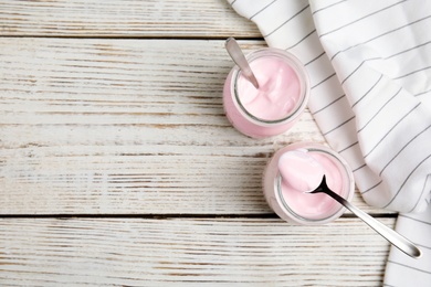 Photo of Flat lay composition with creamy yogurt and space for text on white wooden background