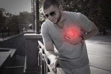 Image of Man having heart attack on city street