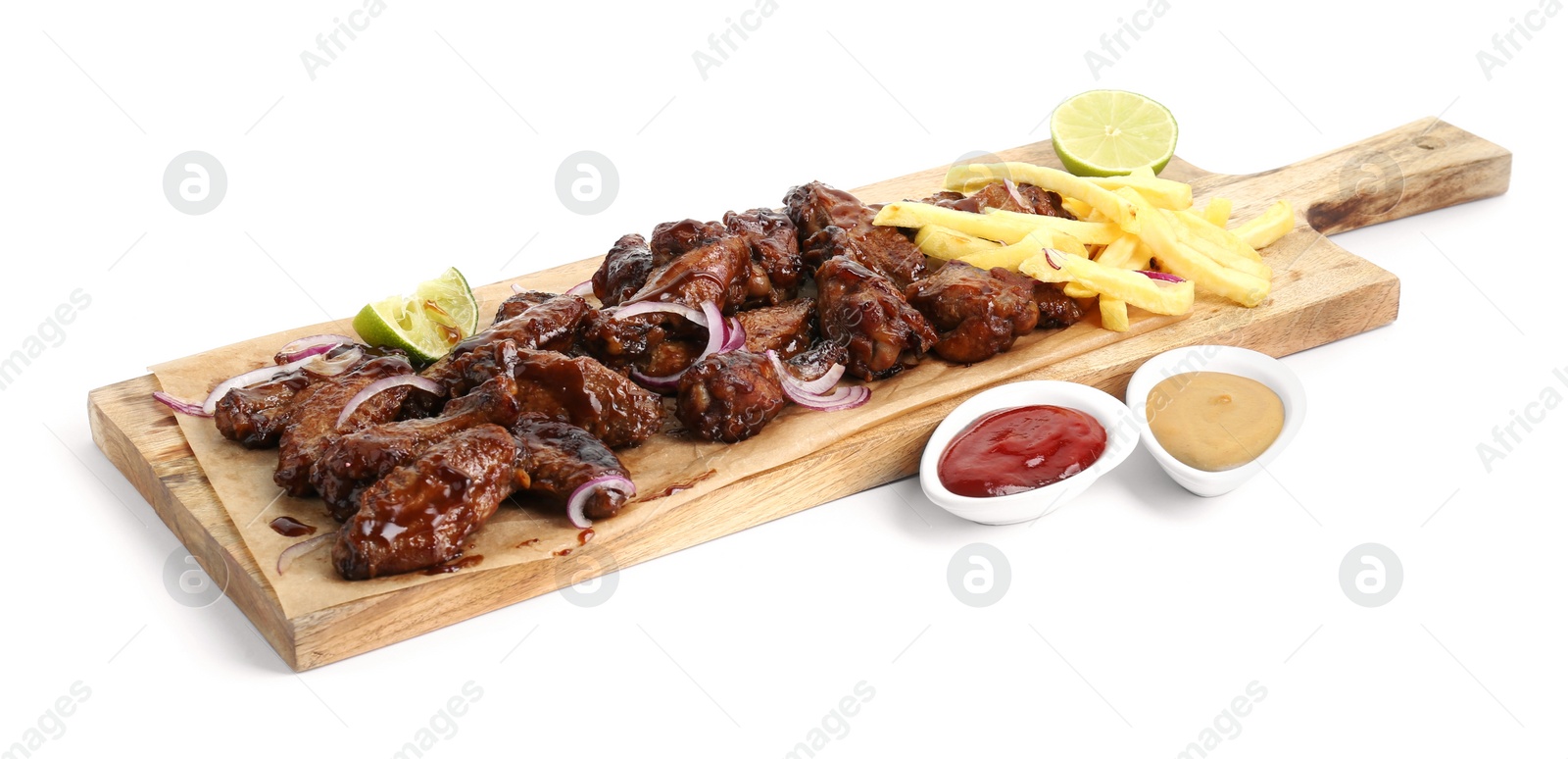 Photo of Wooden board with tasty roasted chicken wings, french fries and sauces isolated on white
