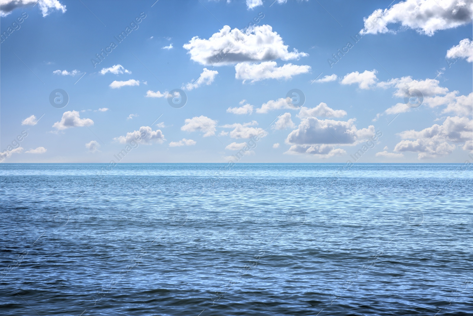 Image of Beautiful view of seascape and blue sky with white clouds on sunny day