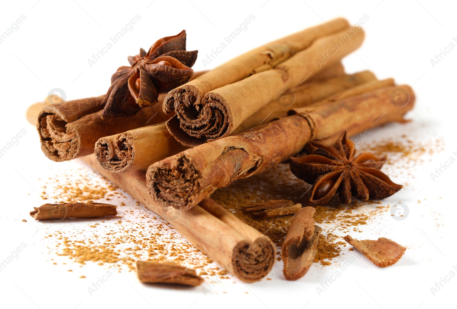 Photo of Dry aromatic cinnamon sticks. powder and anise stars isolated on white