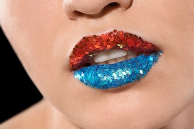 Photo of Beautiful young model with creative lips makeup, closeup