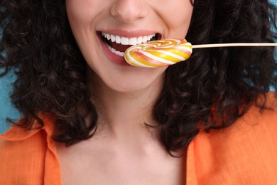 Woman with tasty colorful lollipop, closeup view