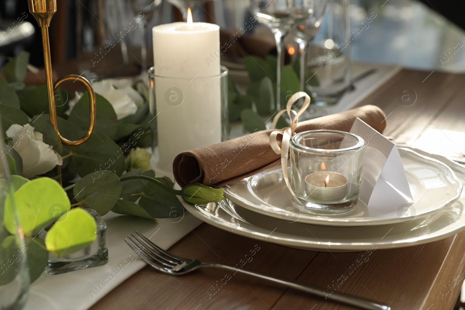 Photo of Elegant table setting with beautiful floral decor and burning candle