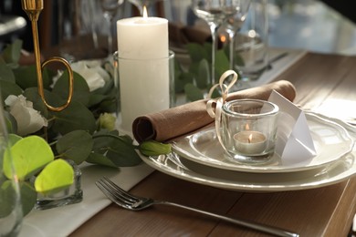 Photo of Elegant table setting with beautiful floral decor and burning candle