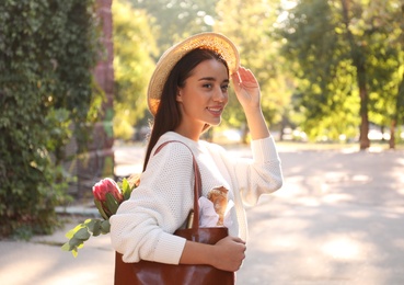 Young woman with leather shopper bag in park