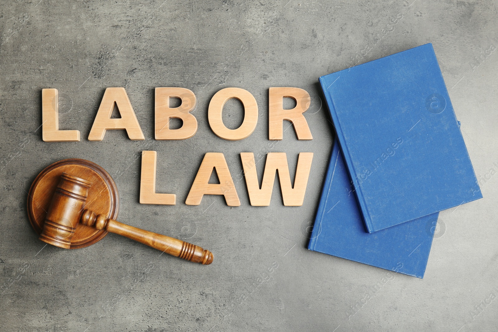 Photo of Flat lay composition with words LABOR LAW on grey background