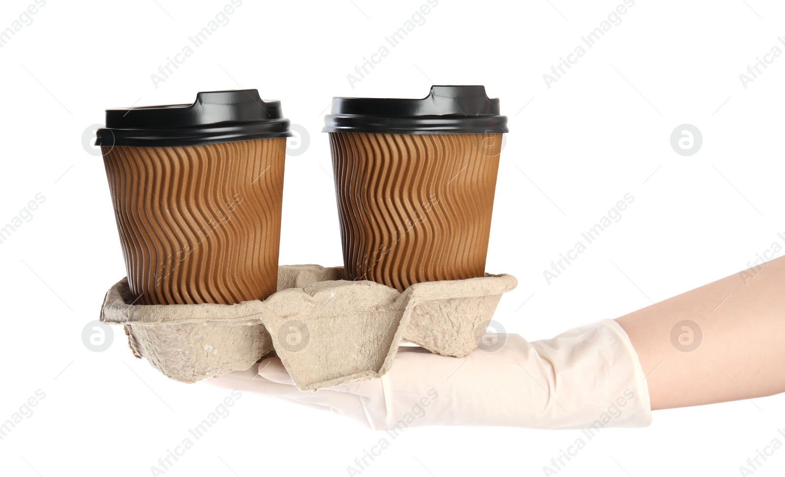 Photo of Woman holding cardboard holder with takeaway paper coffee cups on white background, closeup