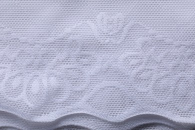 Photo of Beautiful white lace as background, top view