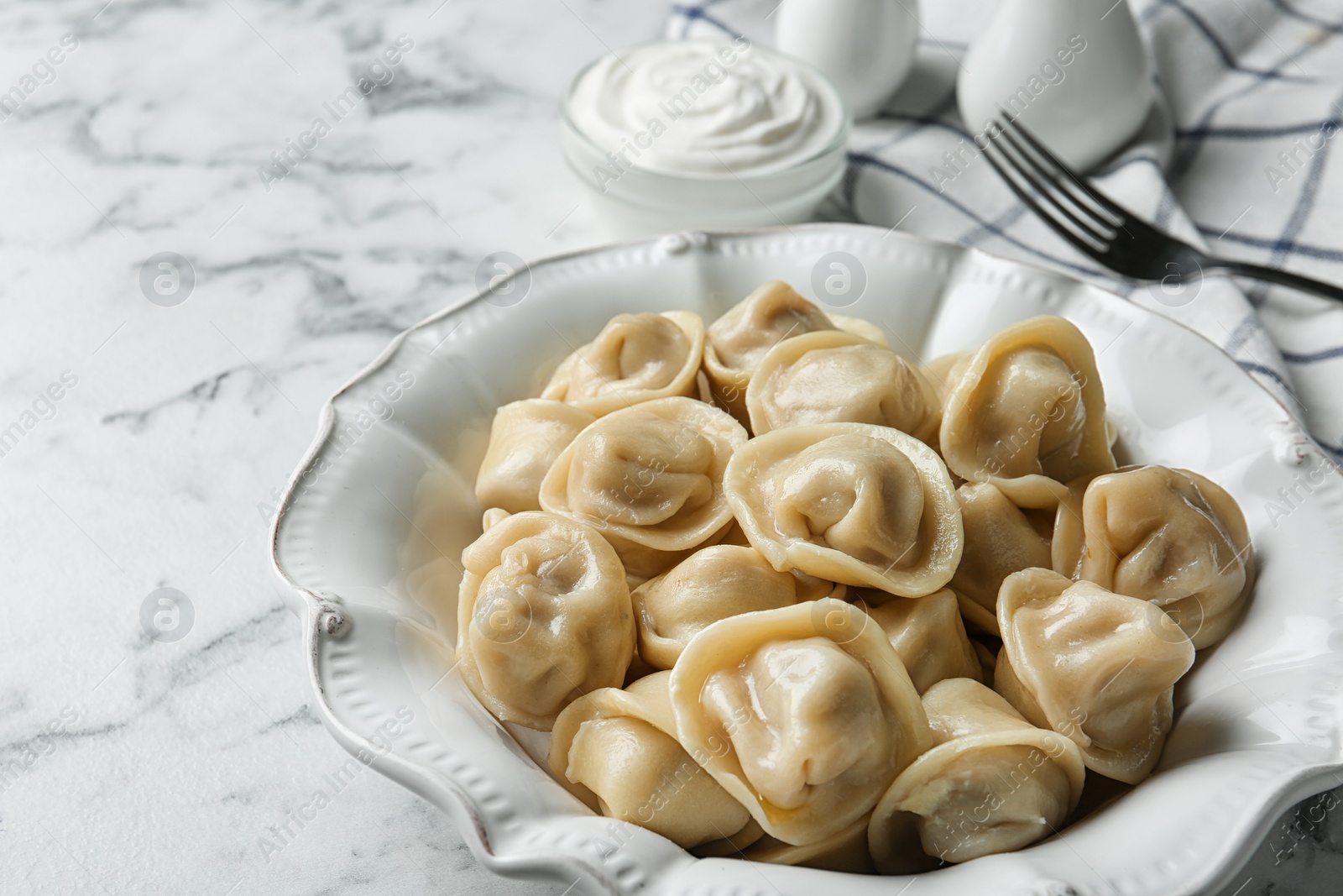 Photo of Portion of tasty dumplings on marble table