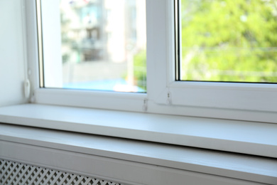 Photo of Closeup view of window with empty white sill