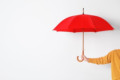 Person holding open umbrella on white background with space for design