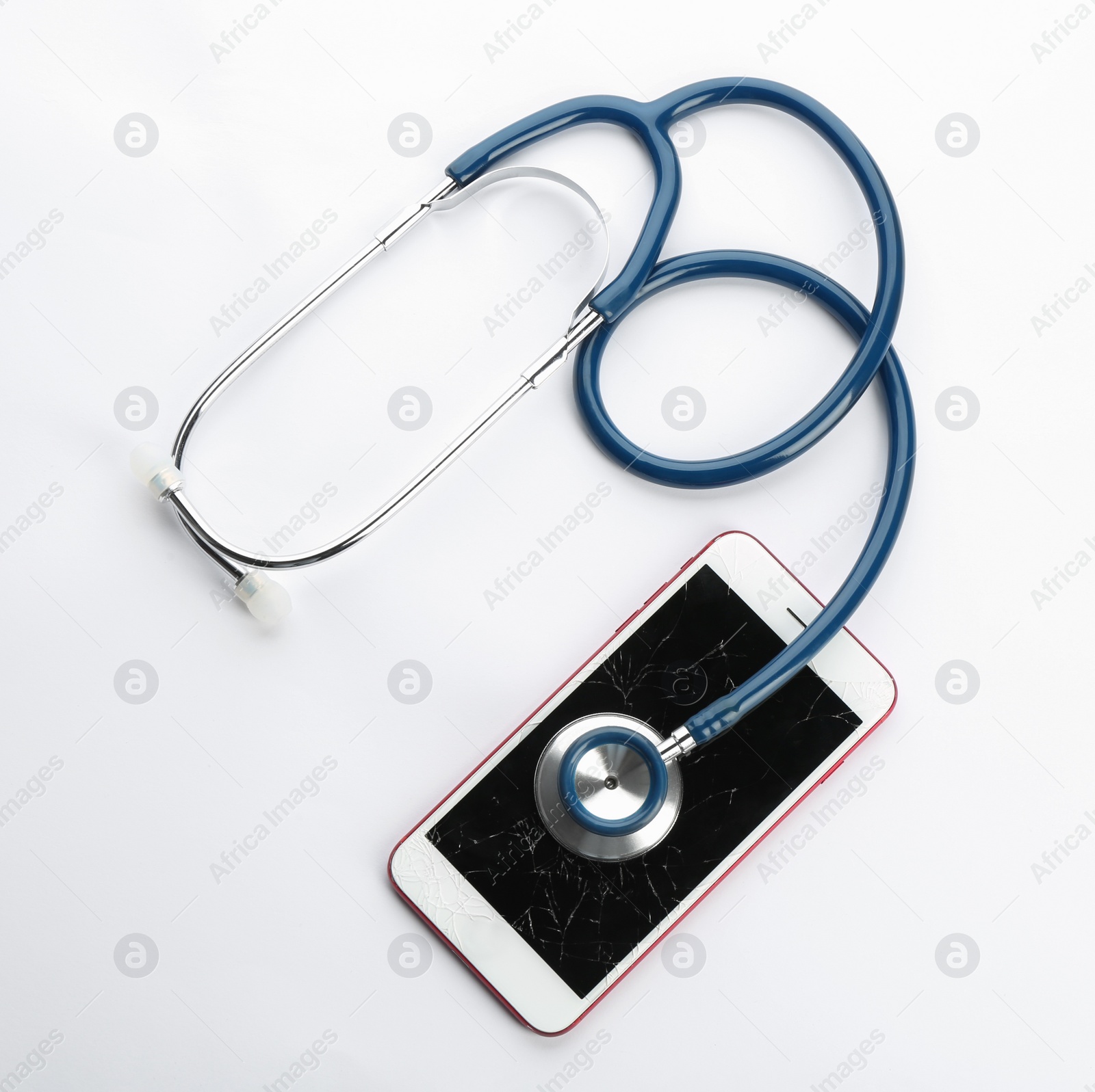 Photo of Modern smartphone with broken display and stethoscope on white background, top view. Device repair service