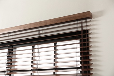 Photo of Modern window with stylish wooden blinds indoors