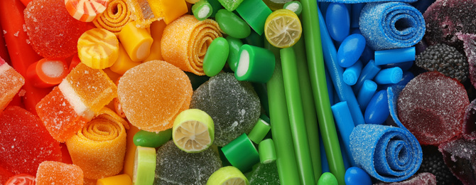 Image of Delicious colorful chewing candies as background, top view. Banner design 