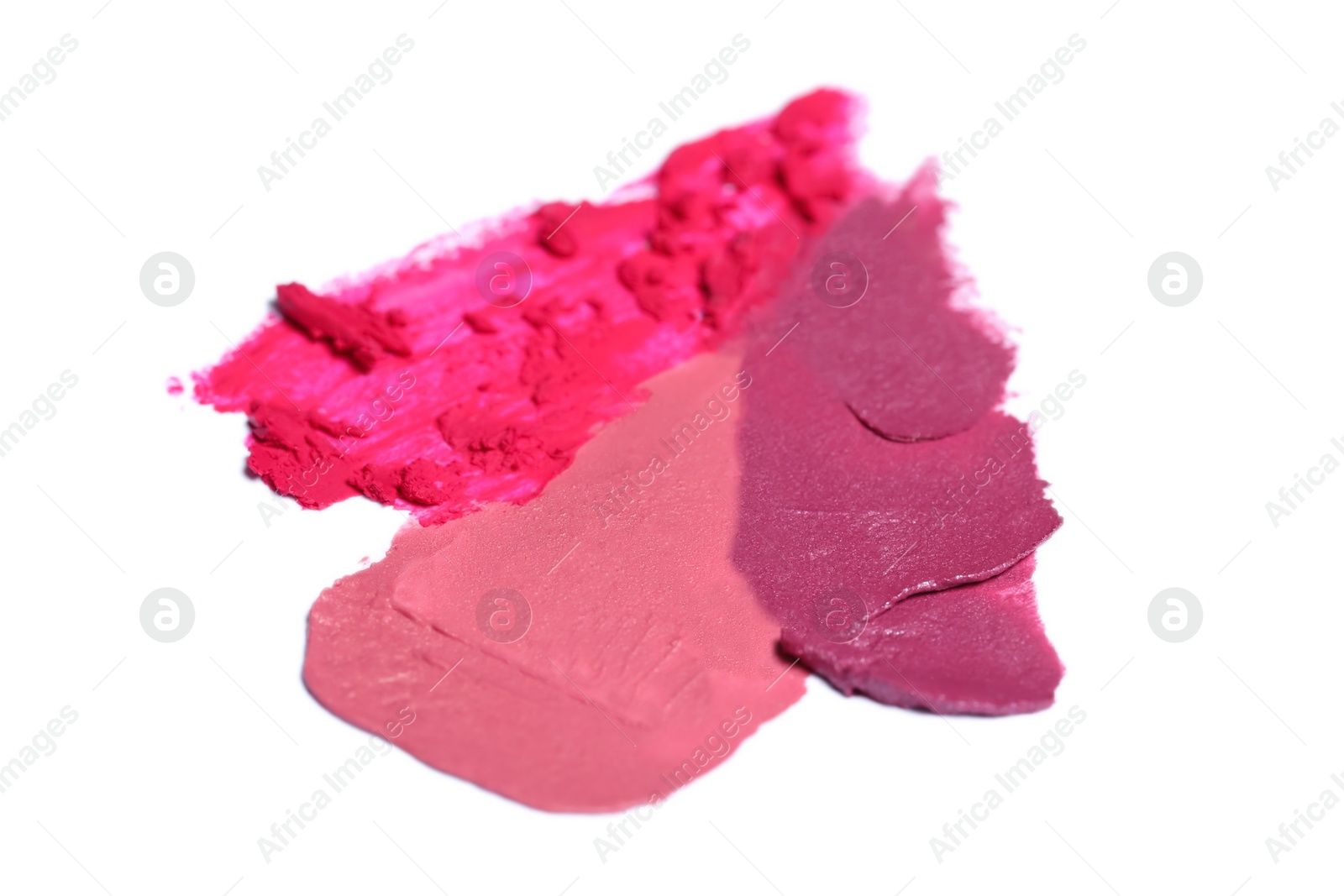 Photo of Smears of bright lipsticks on white background