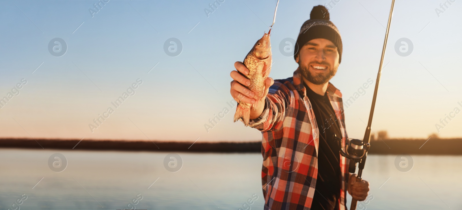 Image of Fisherman with rod and catch at riverside, space for text. Banner design