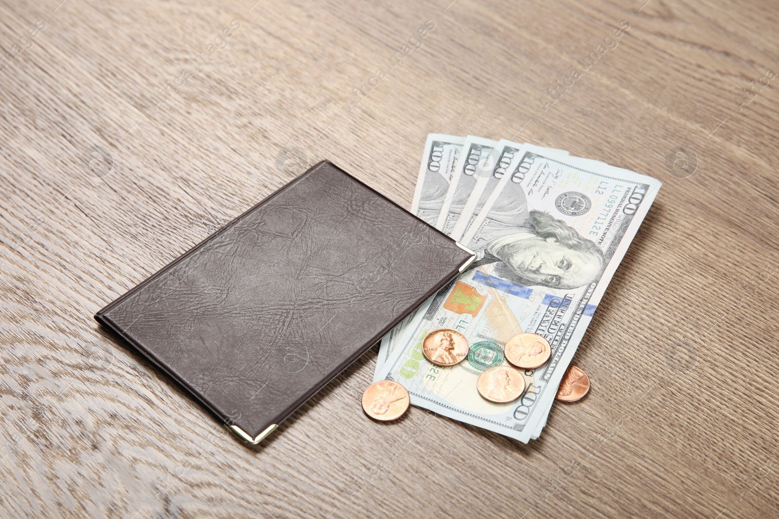 Photo of Pension certificate with American money on brown wooden background