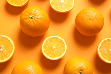 Flat lay composition with ripe oranges on color background