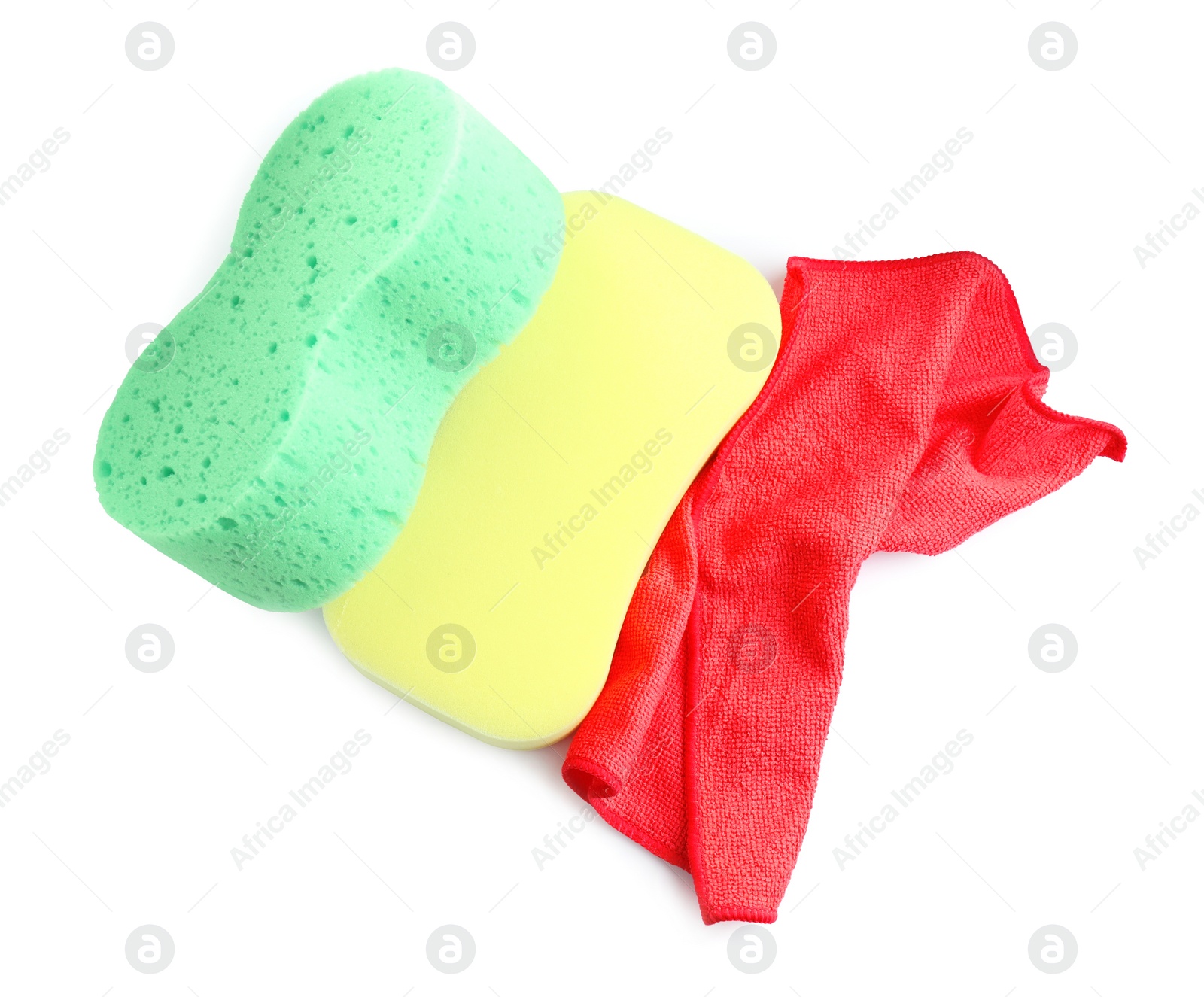 Photo of Sponges and car wash cloth on white background, top view