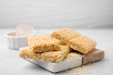 Photo of Delicious sesame kozinaki bars on white table, closeup