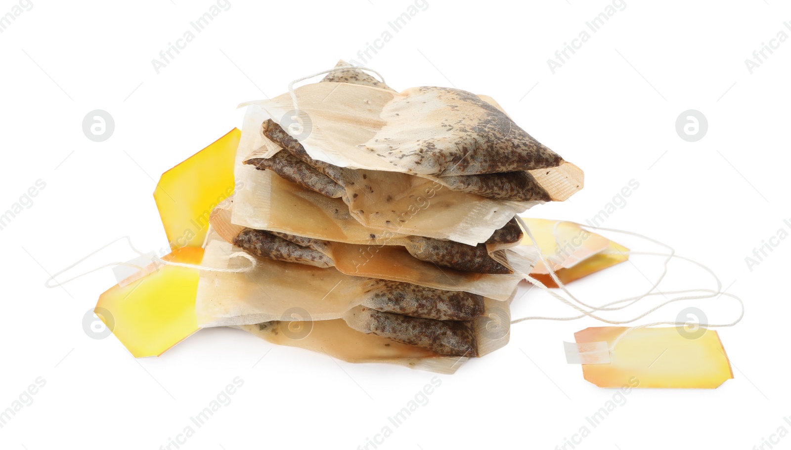 Photo of Many used tea bags on white background